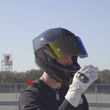 Motorcycle rider wearing grey carbon fiber full face Viper model helmet